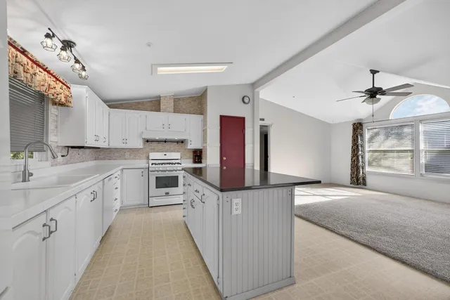 a kitchen with cabinets appliances and a sink