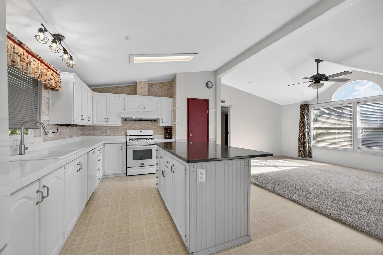 9708 La Clair Road Wilton, CA 95693 - Photo 23 of 60 a kitchen with granite countertop a sink appliances cabinets and counter space