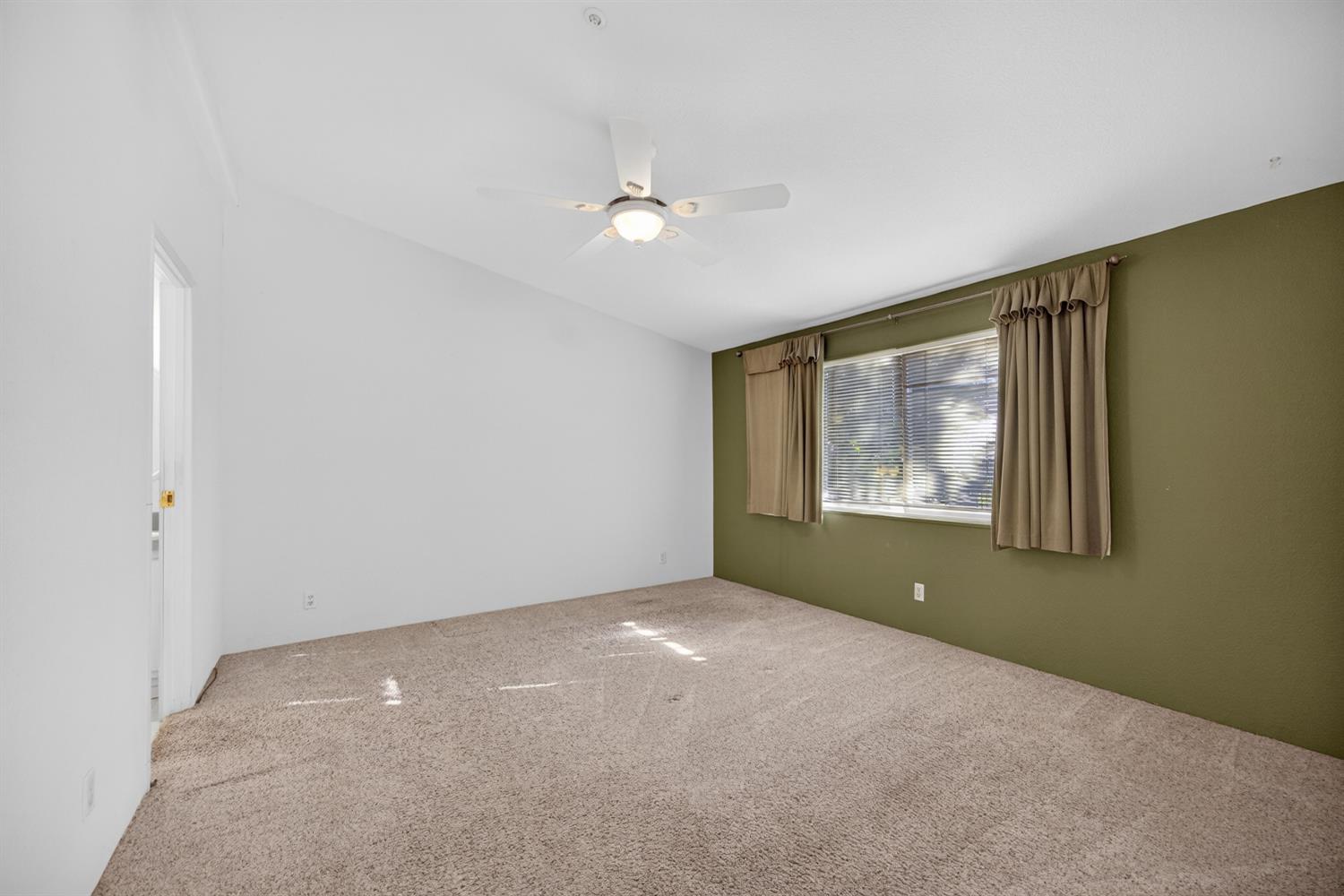 9708 La Clair Road Wilton, CA 95693 - Photo 27 of 60 an empty room with windows and fan