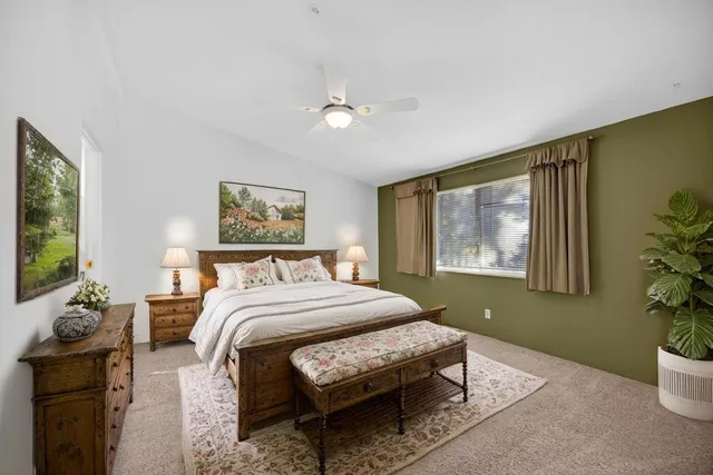 a view of an empty room with a ceiling fan