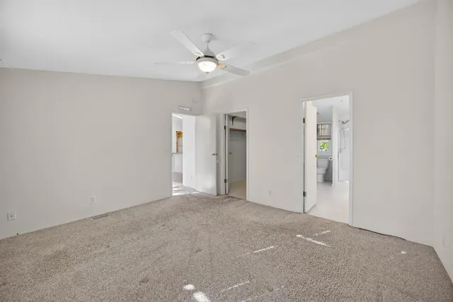 a bathroom with a granite countertop double vanity sink and a mirror