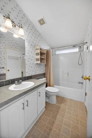 a utility room with cabinets washer and dryer