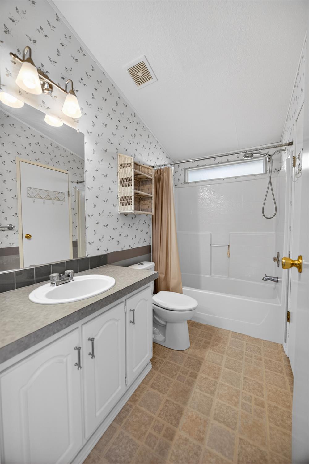 9708 La Clair Road Wilton, CA 95693 - Photo 40 of 60 a bathroom with a granite countertop sink toilet a mirror a bathtub and shower