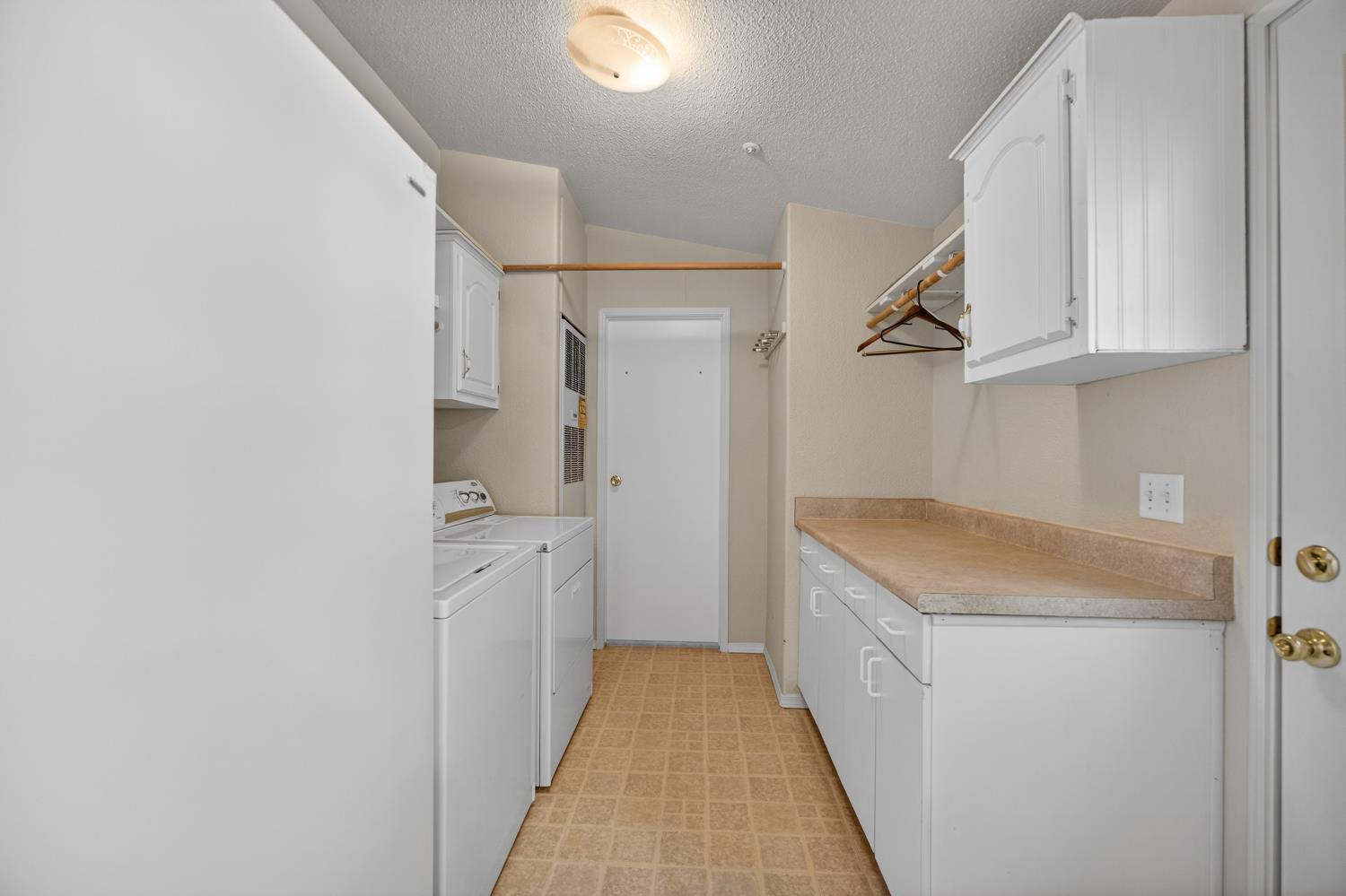 9708 La Clair Road Wilton, CA 95693 - Photo 42 of 60 a utility room with cabinets washer and dryer