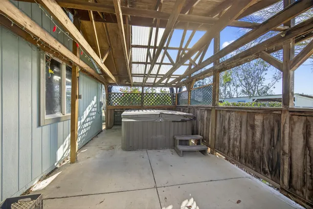 an aerial view of ocean with residential houses with outdoor space and swimming pool