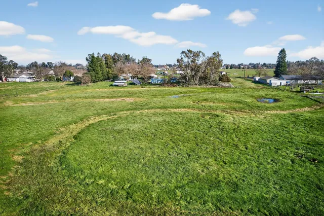 an aerial view of a house with a swimming pool