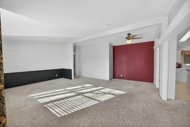 a view of empty room with fireplace and windows