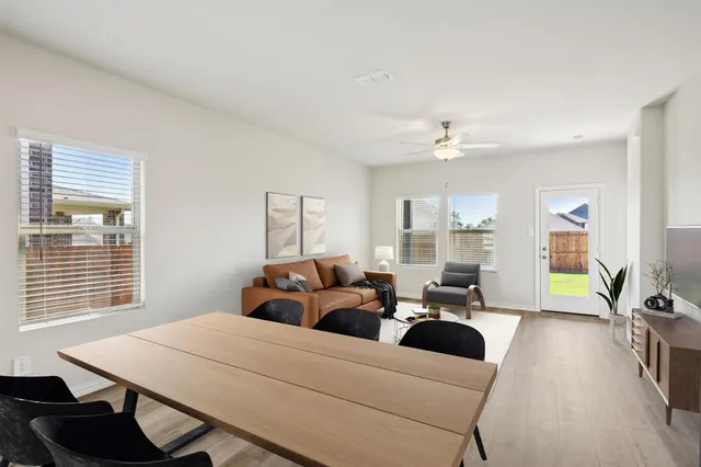 a living room with furniture a window and a chandelier