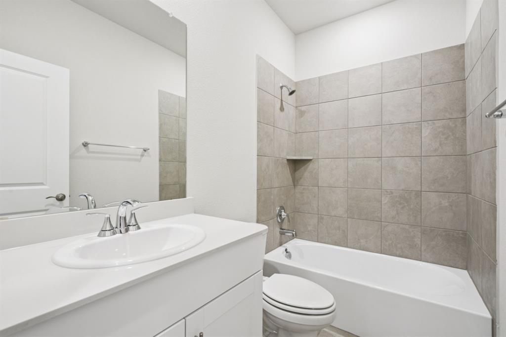 1632 Arches Road Anna, TX 75409 - Photo 13 of 29 a bathroom with a sink a toilet and bathtub