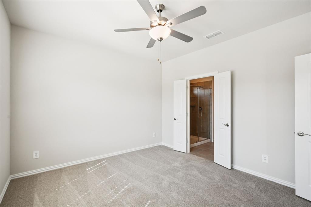 1632 Arches Road Anna, TX 75409 - Photo 16 of 29 an empty room with a ceiling fan and a window