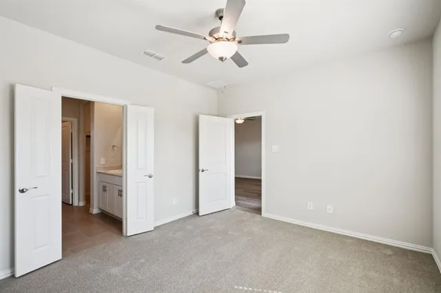 an empty room with fan and a ceiling fan