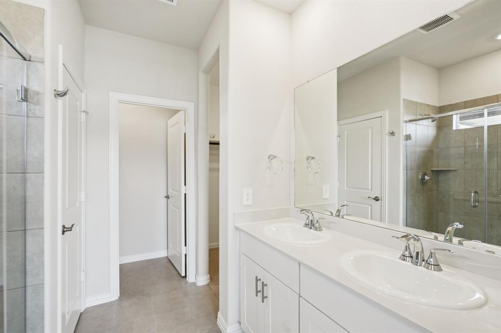 1632 Arches Road Anna, TX 75409 - Photo 19 of 29 a bathroom with a double vanity sink mirror and shower