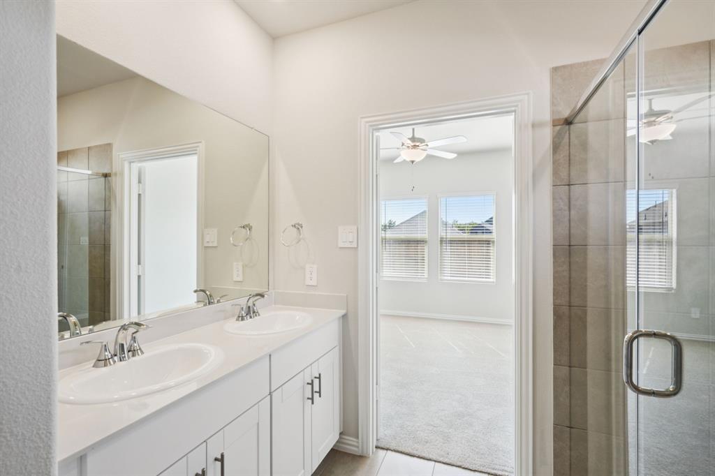 1632 Arches Road Anna, TX 75409 - Photo 21 of 29 a bathroom with a double vanity sink mirror and shower