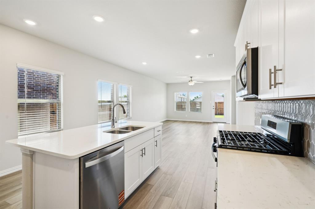 1632 Arches Road Anna, TX 75409 - Photo 4 of 29 a kitchen with a sink stove and cabinets