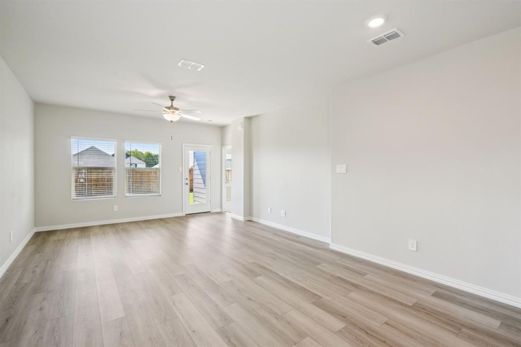 1632 Arches Road Anna, TX 75409 - Photo 9 of 29 wooden floor in an empty room with a window
