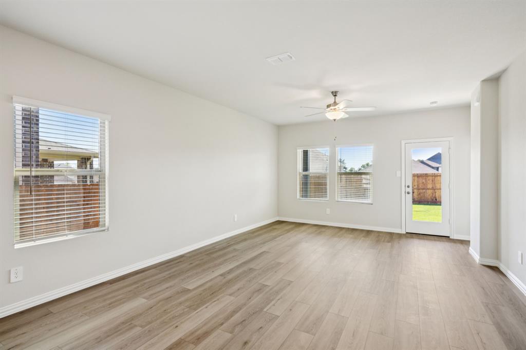 1632 Arches Road Anna, TX 75409 - Photo 10 of 29 a view of an empty room with a window and wooden floor