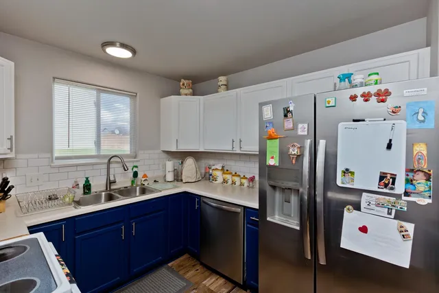a kitchen with refrigerator and cabinets
