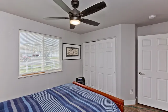 a bedroom with a bed and a window