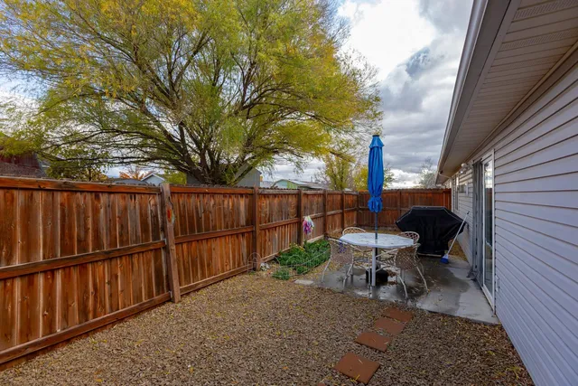 a view of a house with backyard and sitting area