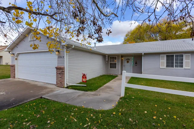 a view of a house with pool and a yard