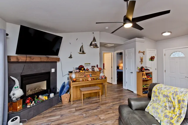 a living room with furniture a flat screen tv and a fireplace