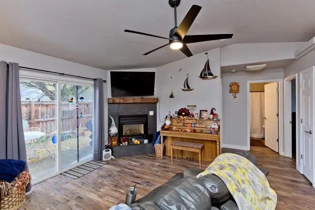 a living room with furniture a flat screen tv and a fireplace