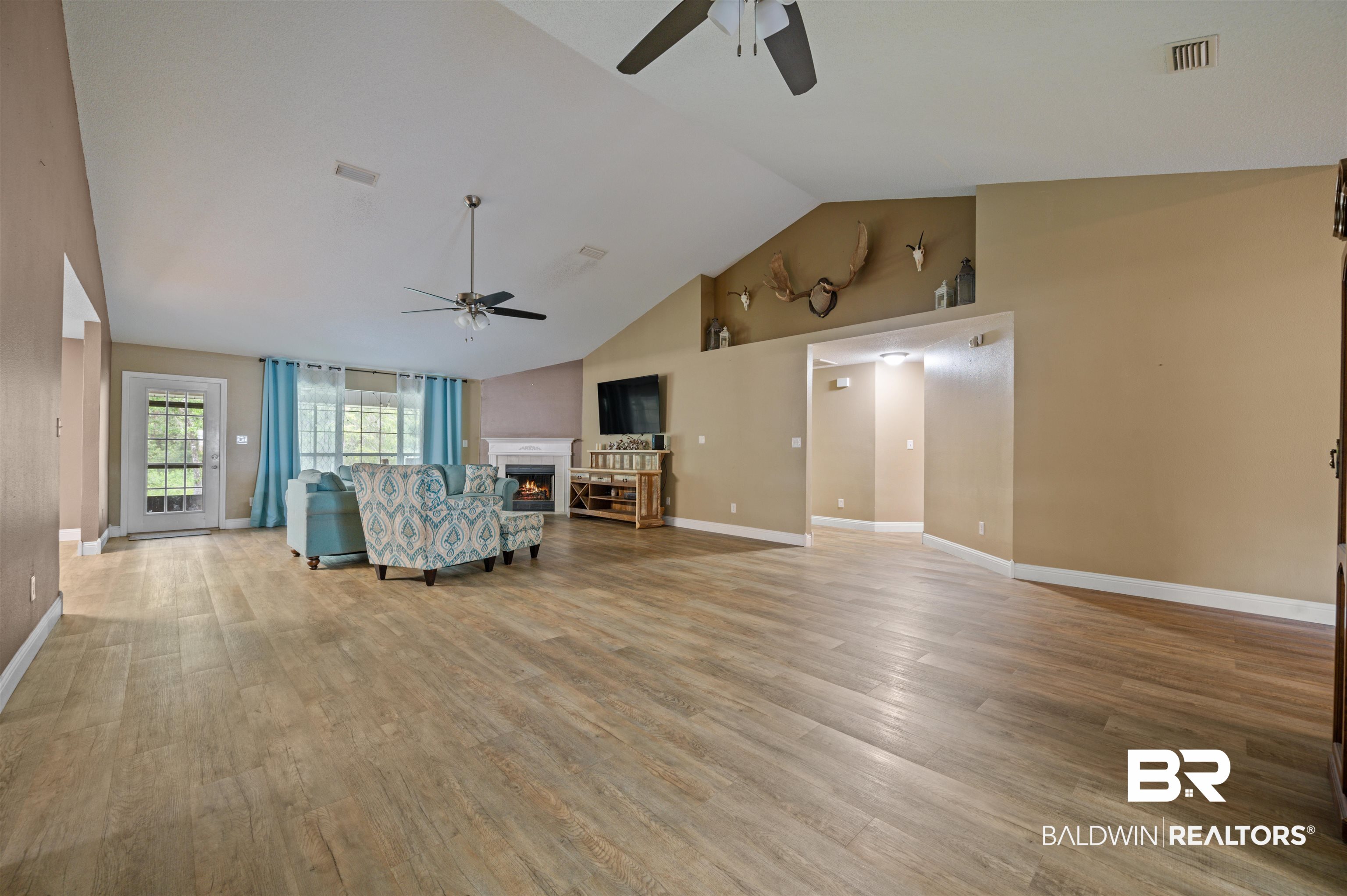 11705 Venice Boulevard Foley, AL 36535 - Photo 15 of 43 Unfurnished living room featuring high vaulted ceiling, ceiling fan, and hardwood / wood-style flooring