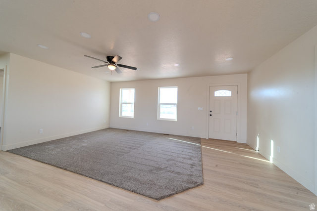 130 Pole Line Road, Unit 2 Roosevelt, UT 84066 - Photo 32 of 33 Living area featuring light wood-finish flooring and a gray carpet inlay