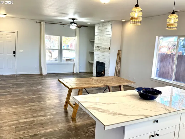 a kitchen with kitchen island a stove and a wooden floors