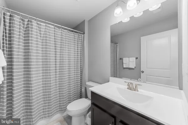 a bathroom with a sink a toilet and mirror