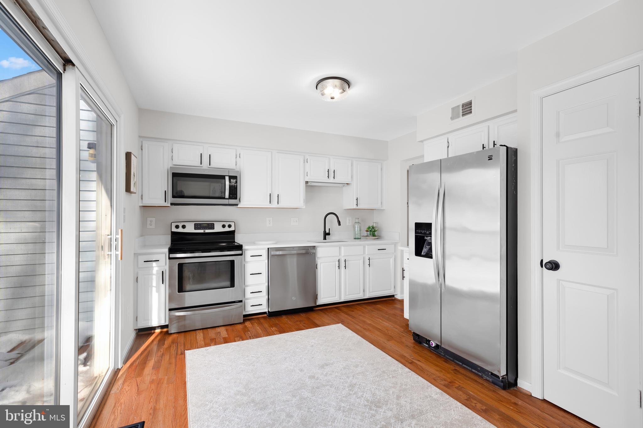 9005 Triple Ridge Road Fairfax Station, VA 22039 - Photo 11 of 38 a kitchen with stainless steel appliances a refrigerator sink and microwave