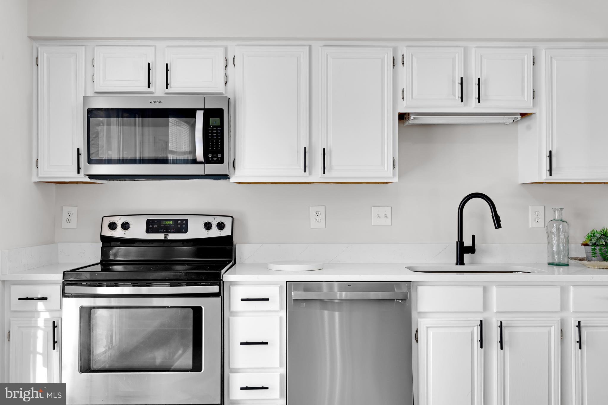 9005 Triple Ridge Road Fairfax Station, VA 22039 - Photo 12 of 38 a kitchen with stainless steel appliances granite countertop a sink dishwasher a stove and a microwave oven with cabinets