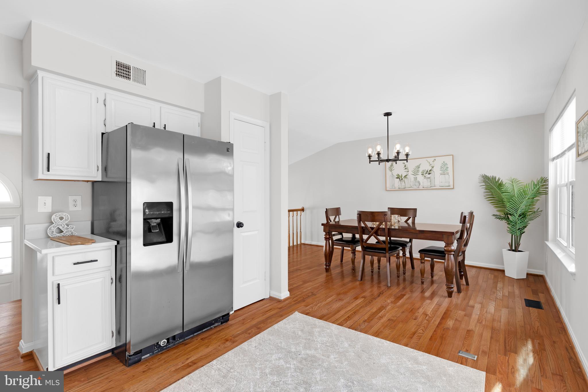 9005 Triple Ridge Road Fairfax Station, VA 22039 - Photo 13 of 38 a view of a dining room with furniture and wooden floor