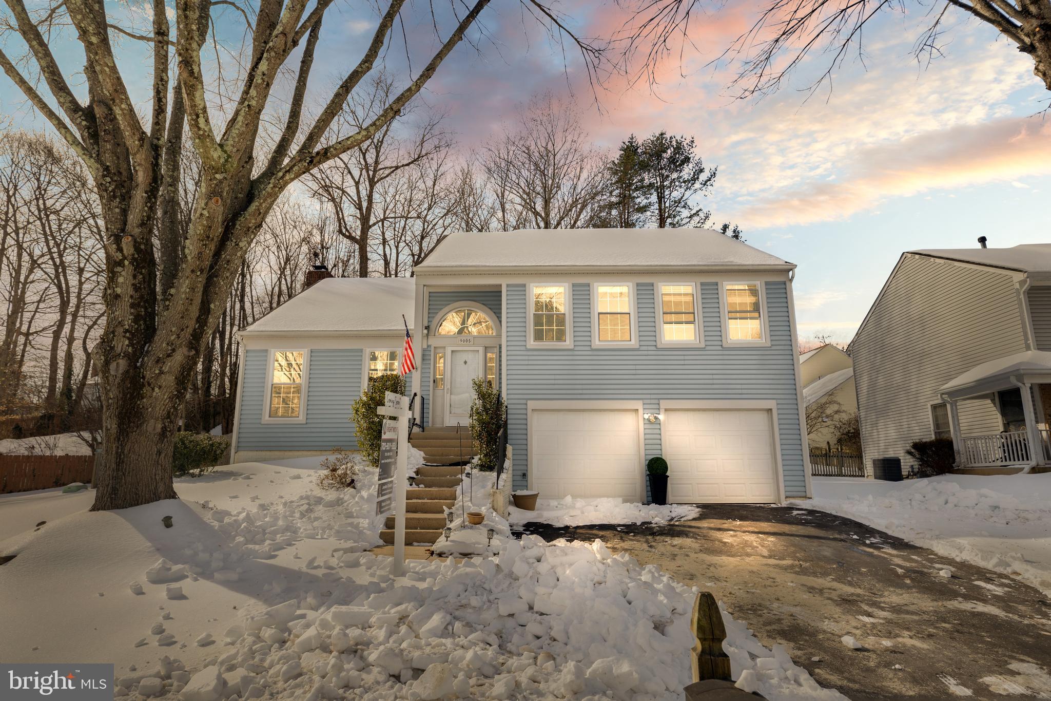 9005 Triple Ridge Road Fairfax Station, VA 22039 - Photo 2 of 38 a front view of a house with a yard and garage