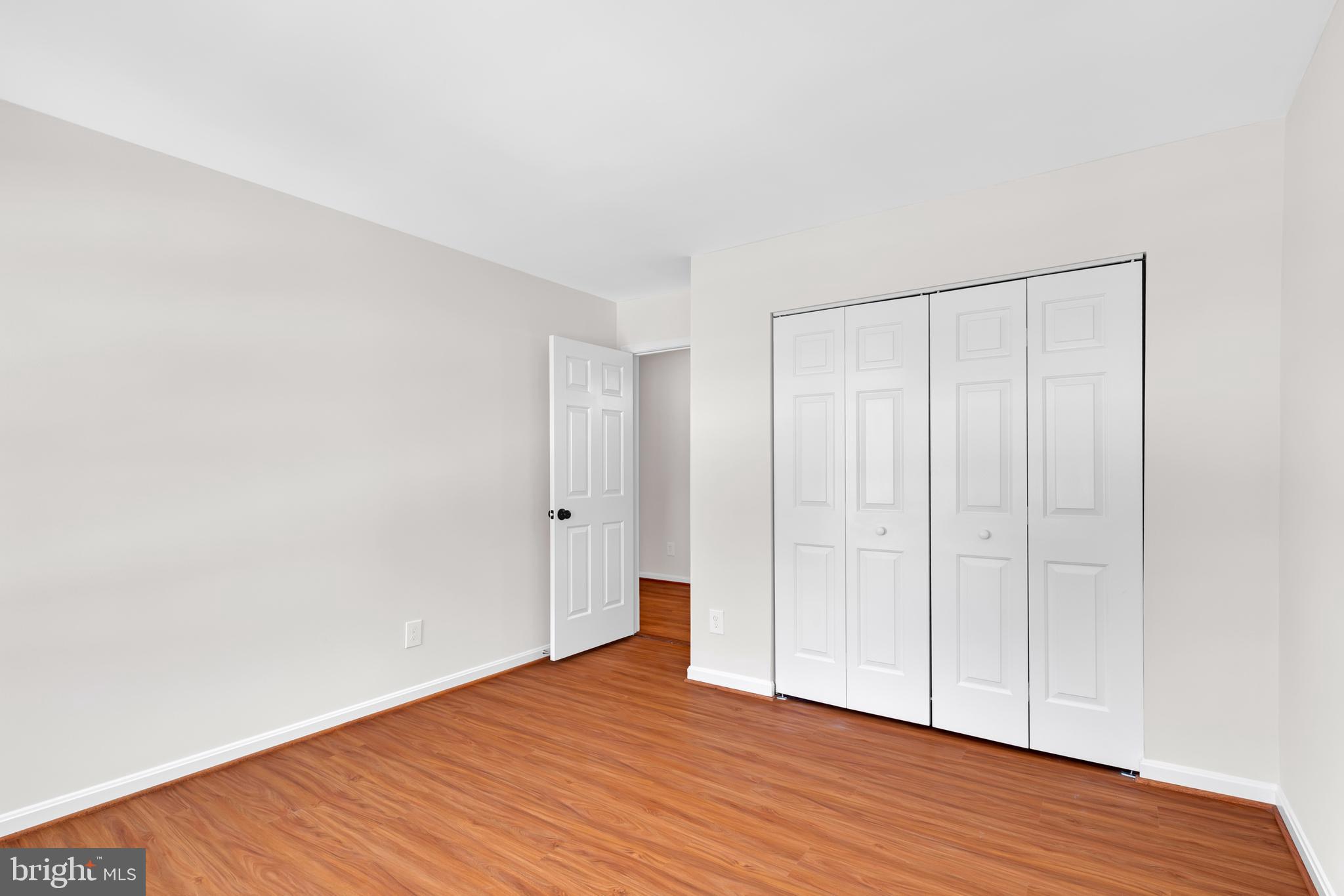 9005 Triple Ridge Road Fairfax Station, VA 22039 - Photo 22 of 38 a view of an empty room with wooden floor