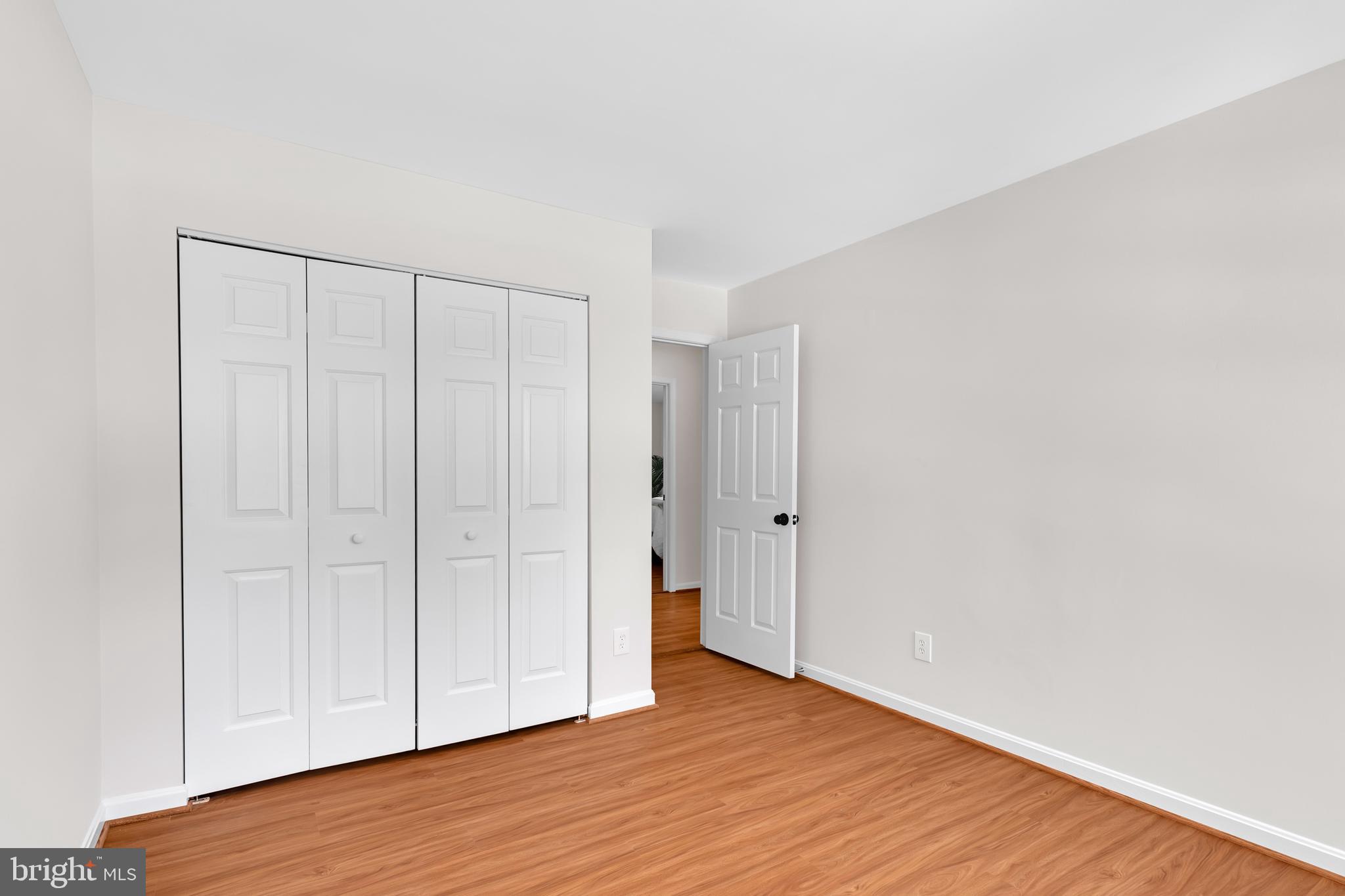 9005 Triple Ridge Road Fairfax Station, VA 22039 - Photo 24 of 38 a view of an empty room with wooden floor