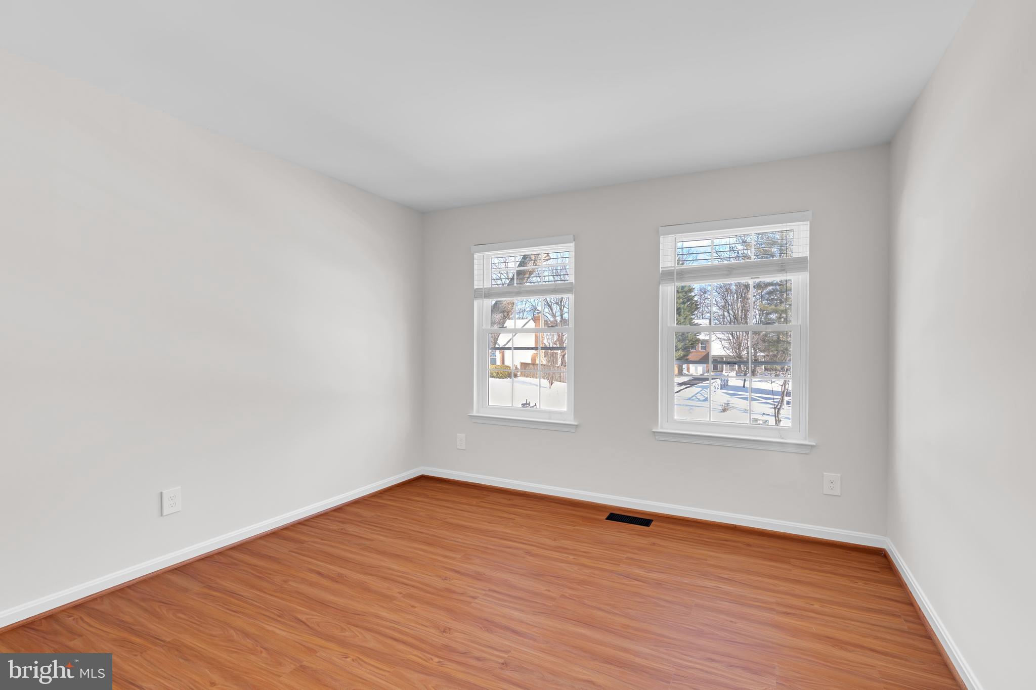 9005 Triple Ridge Road Fairfax Station, VA 22039 - Photo 25 of 38 an empty room with wooden floor and windows