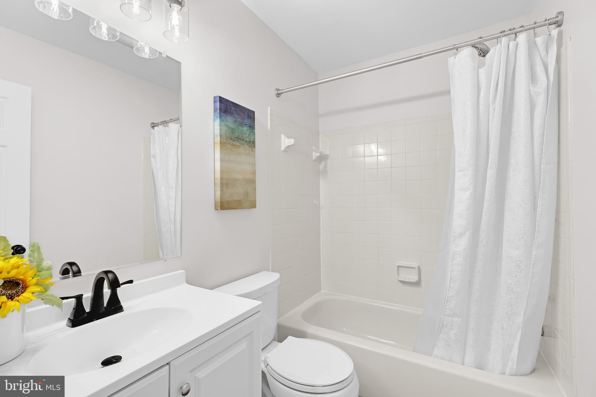 9005 Triple Ridge Road Fairfax Station, VA 22039 - Photo 26 of 38 a bathroom with a sink a toilet and shower