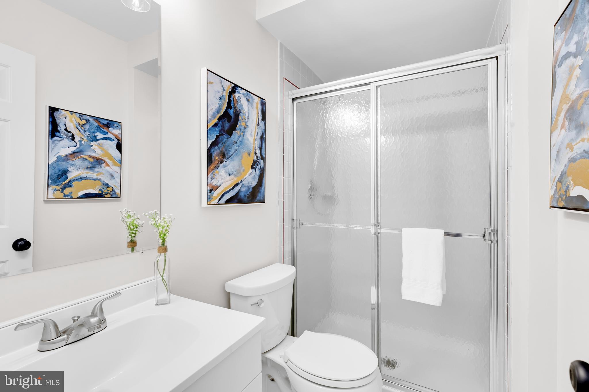 9005 Triple Ridge Road Fairfax Station, VA 22039 - Photo 30 of 38 a white toilet sitting next to a bathroom sink