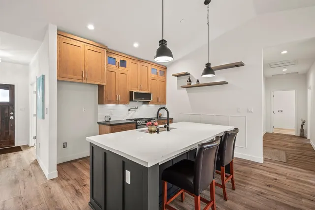 a kitchen with a table a sink and cabinets