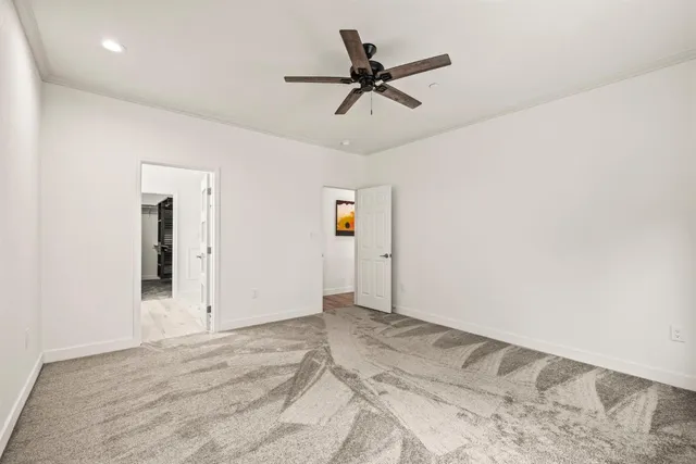 a view of a livingroom with wooden floor and a ceiling fan