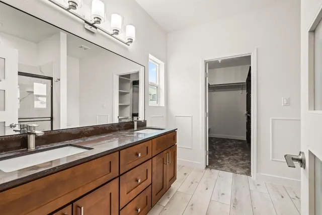 a spacious bathroom with a granite countertop sink mirror and double