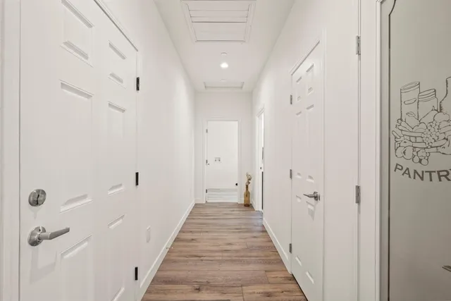 a kitchen with white cabinets and sink