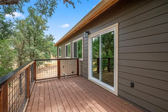 a front view of a house with a tree