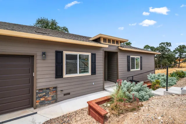a front view of a house with garden