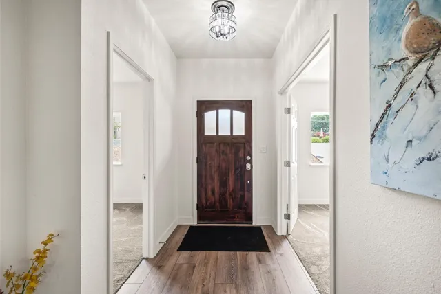 a view of a hallway view with wooden floor and staircase