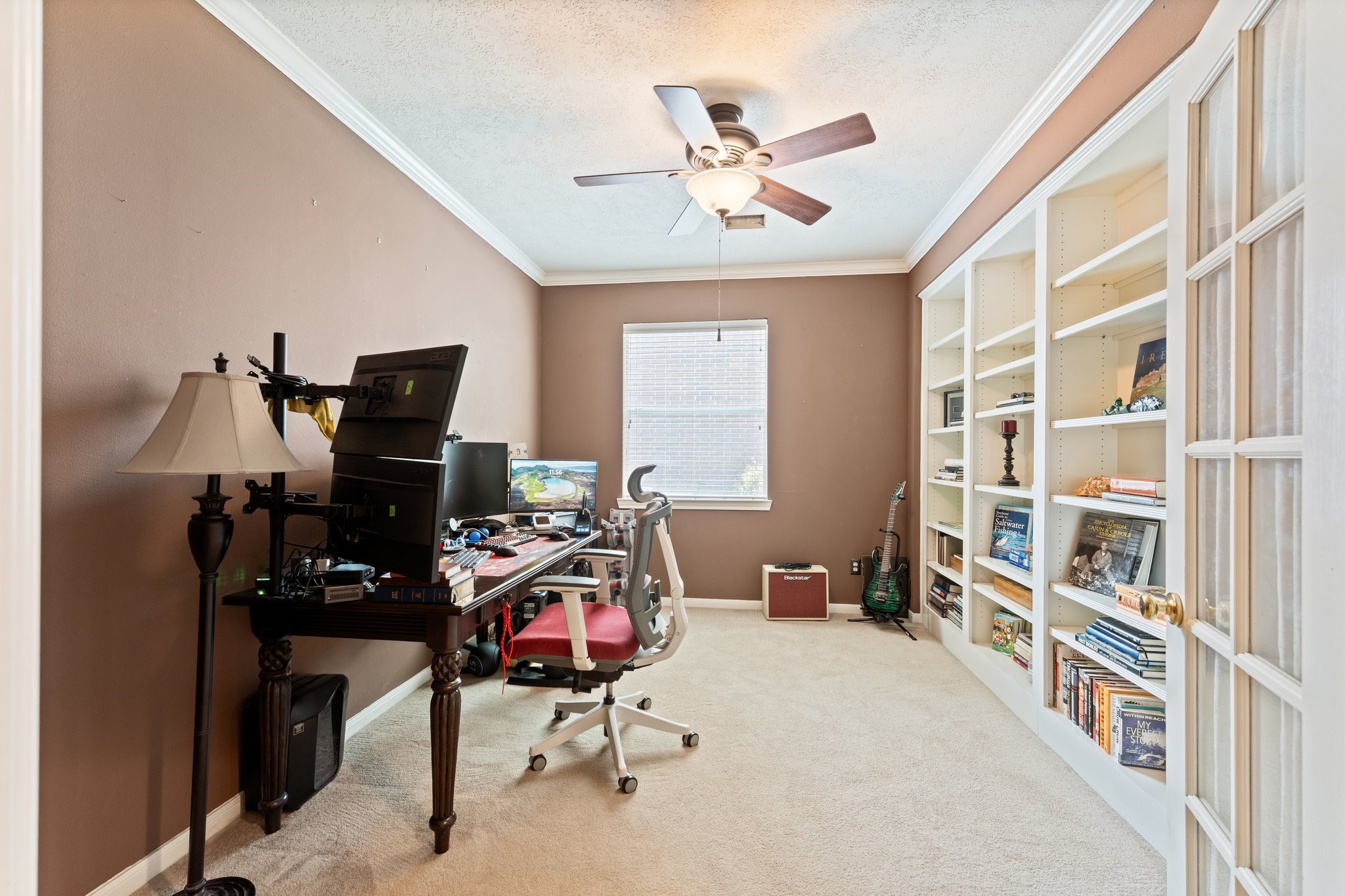 25447 China Springs Spring, TX 77373 - Photo 18 of 45 Whether you're working remotely, managing a busy household, or pursuing a passion project, this large private office with built in shelves provides the quiet space to stay focused and productive.