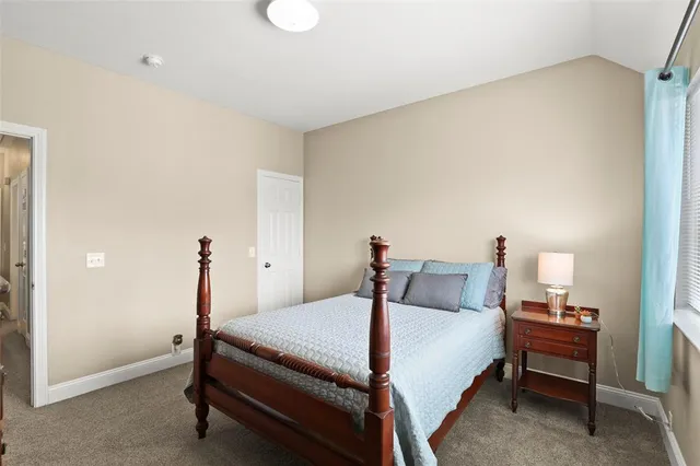 a bedroom with a bed and a table