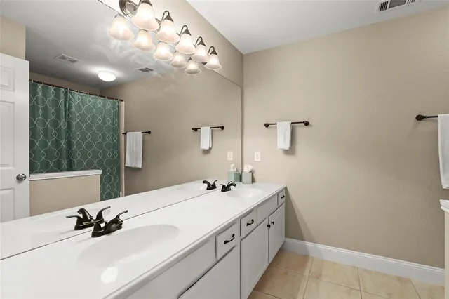 a bathroom with a sink a light fixture and a mirror