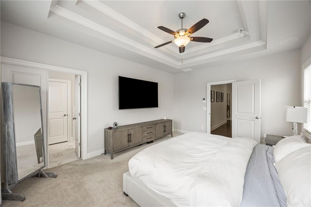 1799 Falling Sky Court Atlanta, GA 30319 - Photo 12 of 26 a bedroom with a bed and a flat screen tv